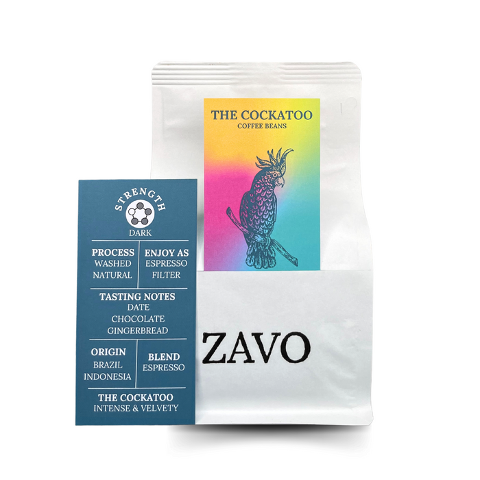 A white coffee bag with a black ZAVO logo stamped on the bottom of the bag, there is two product cards one is multicoloured with a Cockatoo on it, the second is the Tasting Notes which says Strength Dark, Process Washed Natural, Enjoy as Espresso Filter, Tasting Notes Date, Chocolate, Gingerbread, Origin Brazil, Indonesia, Blend Espresso, The cockatoo Intense and Velvety