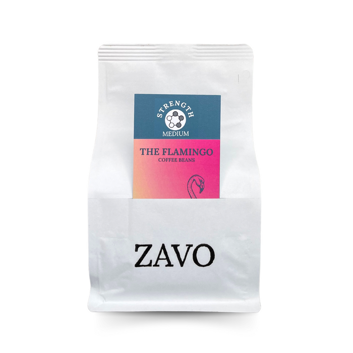 A white coffee bag with a black ZAVO logo stamped on. It has two product cards, one is a pink card with a Flamingo on, the other is a blue tasting notes card which says Strength Medium.